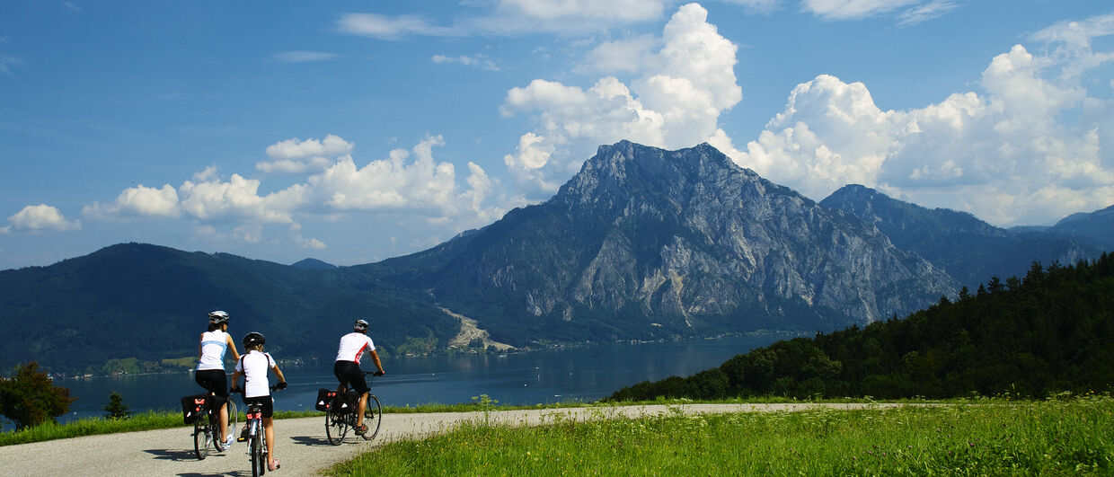 Family cycling trip around a beautiful mountain lake